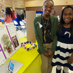 Students discuss their research during community event. 