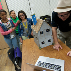 Students demonstrate the features of their tiny home. 