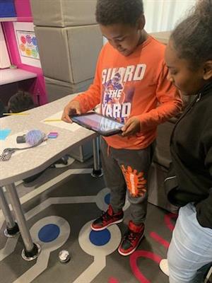 Killeen ISD students working on ipad coding a robot