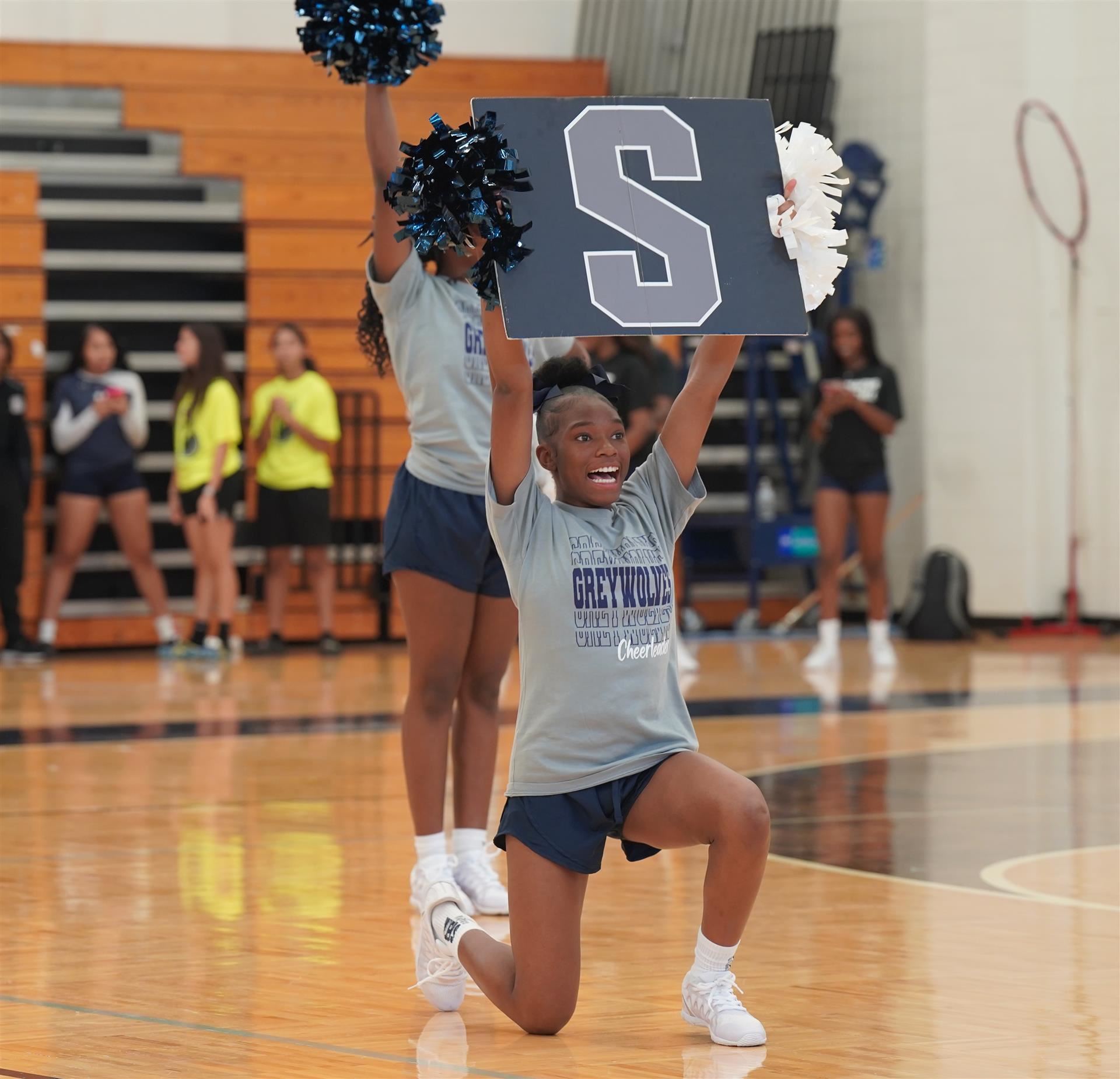 Cheerleader holds a sign