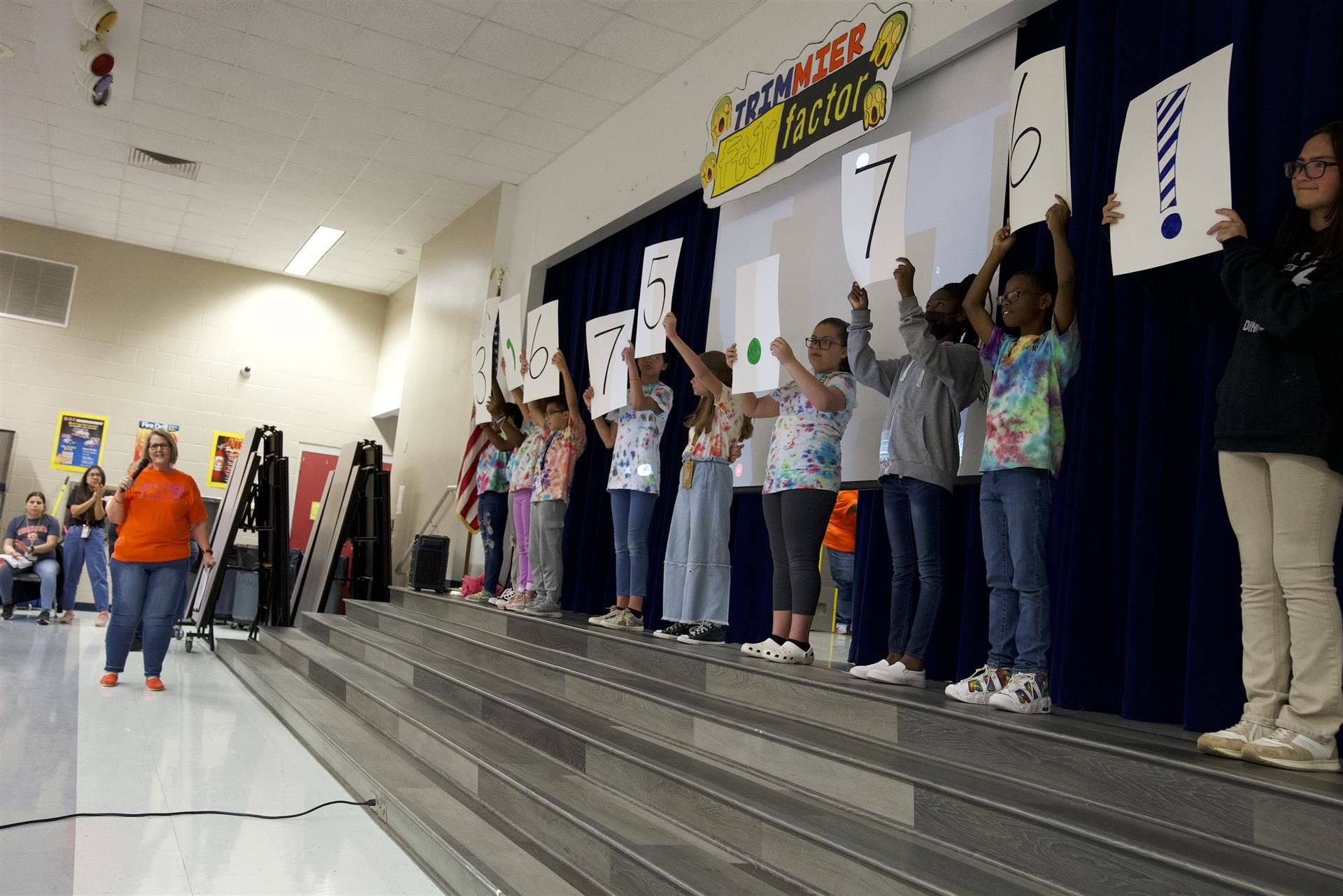Students holding up numbers