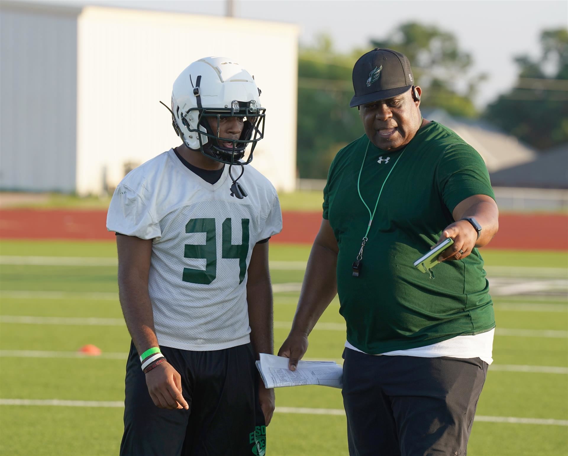 Coach talks with a player