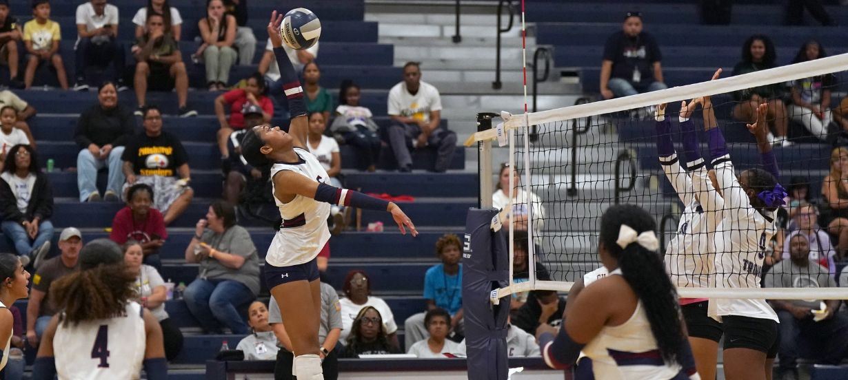Volleyball players spikes the ball