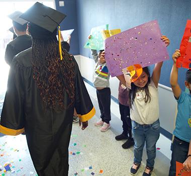 Young students congratulate seniors set to graduate