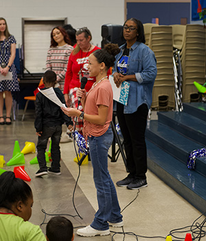 Student speaking at a microphone