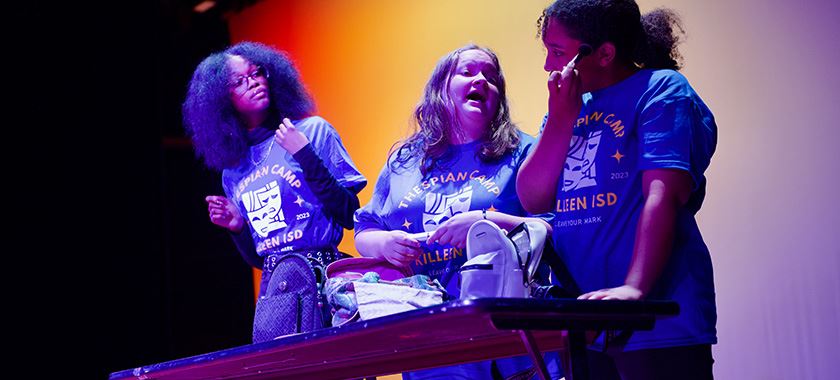  Theater campers act a scene during a showcase for parents